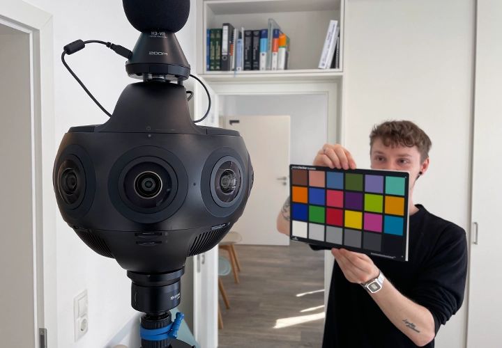 During a 360° shoot, an assistant holds a color chart in front of the omnidirectional camera