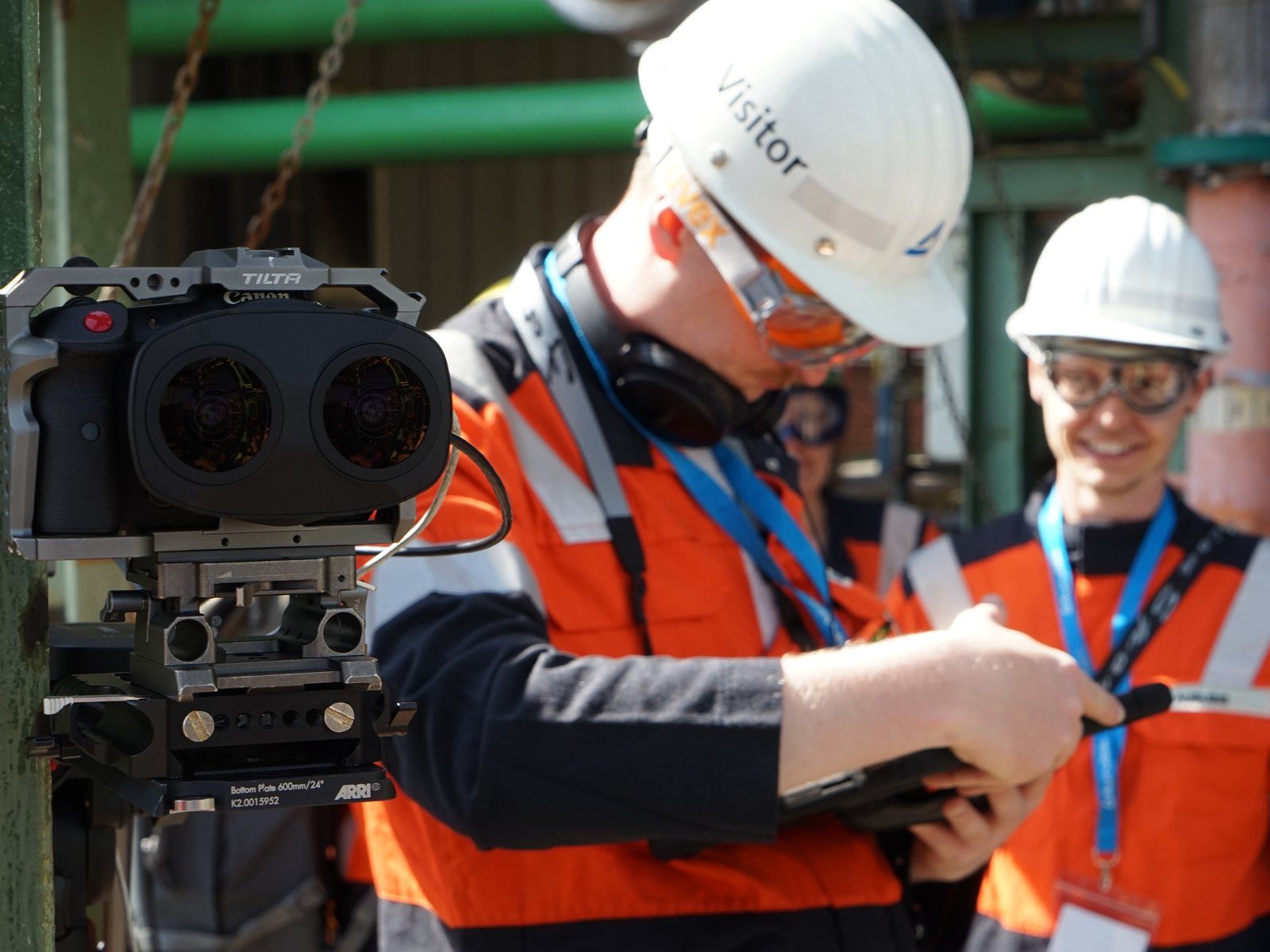 Team member in helmet and safety jacket sets up a 180° stereo camera