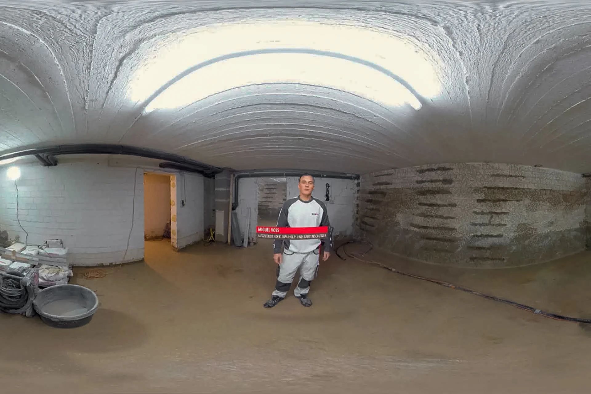 360°-Aufnahme aus einem Kellerraum auf einer Baustelle, in der Mitte Azubi Miguel in Arbeitskleidung mit eingeblendetem Namensbalken