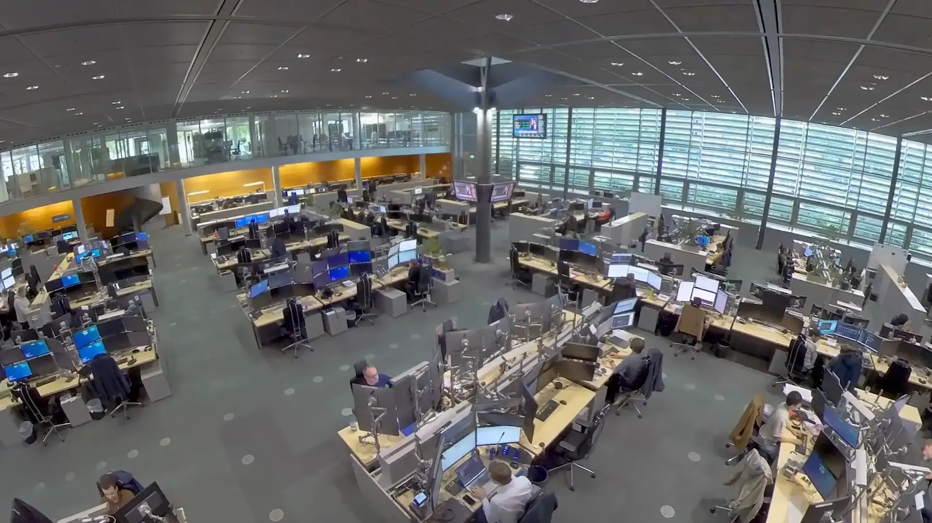 Overhead view of the trading floor with numerous workstations and monitors