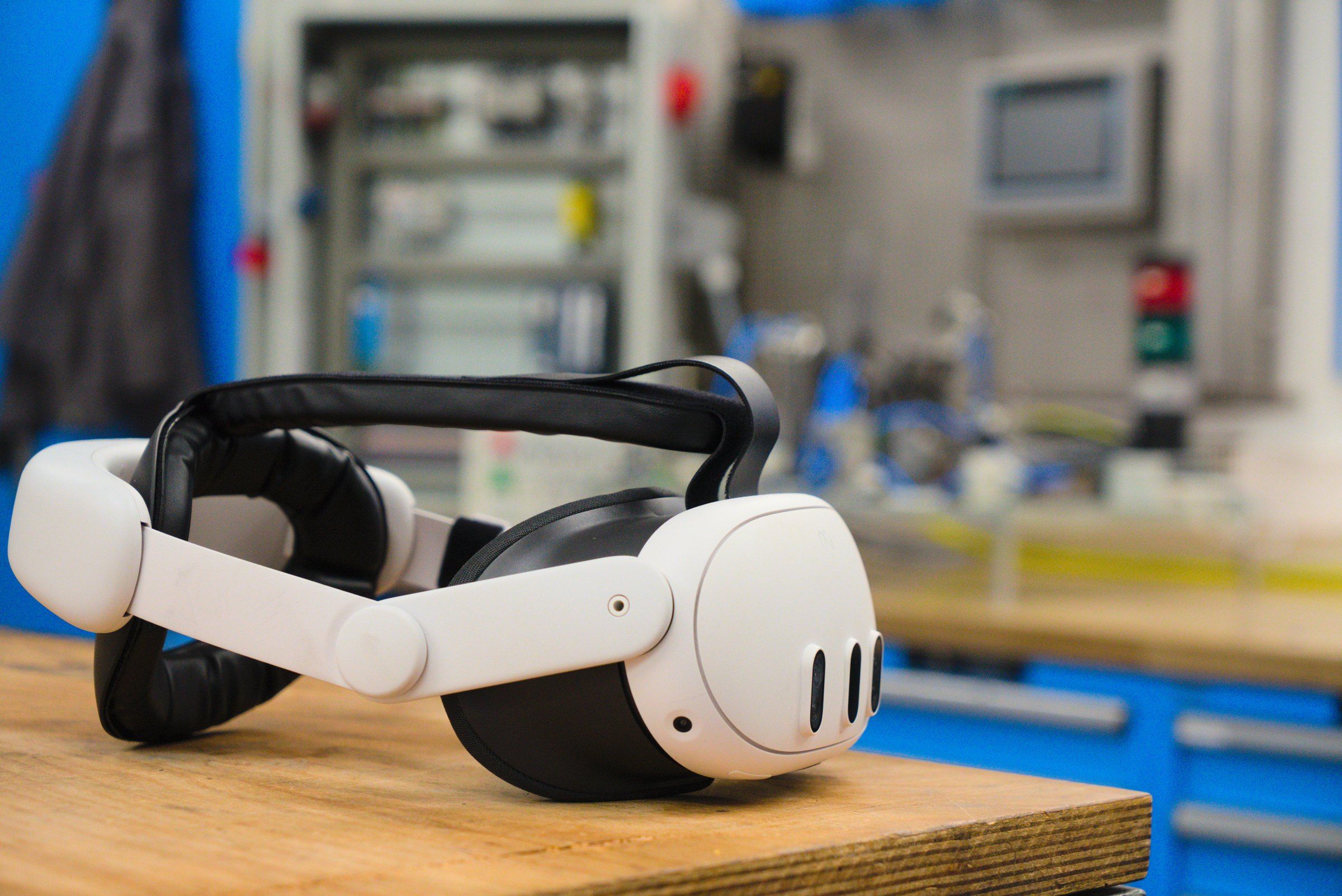 A VR headset rests on a workbench in a training workshop