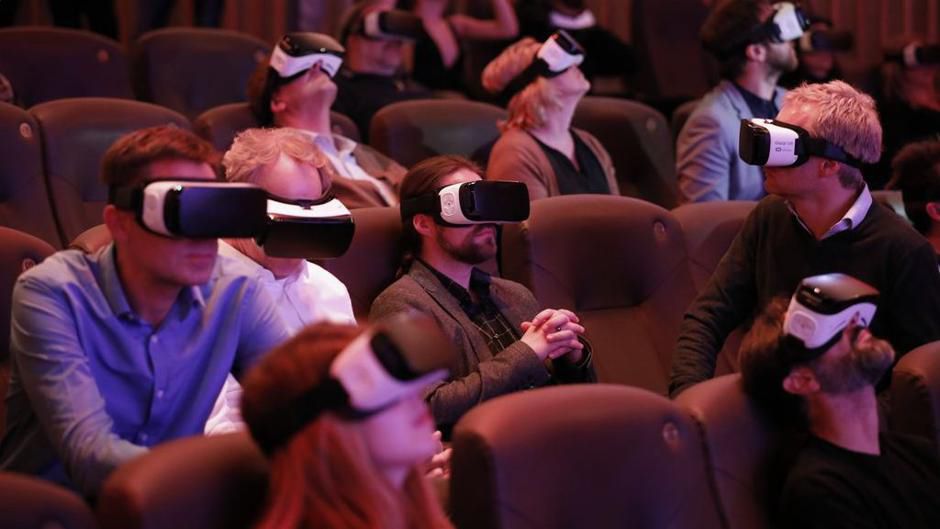 A full auditorium where every viewer wears a VR headset and watches the same film at the same time