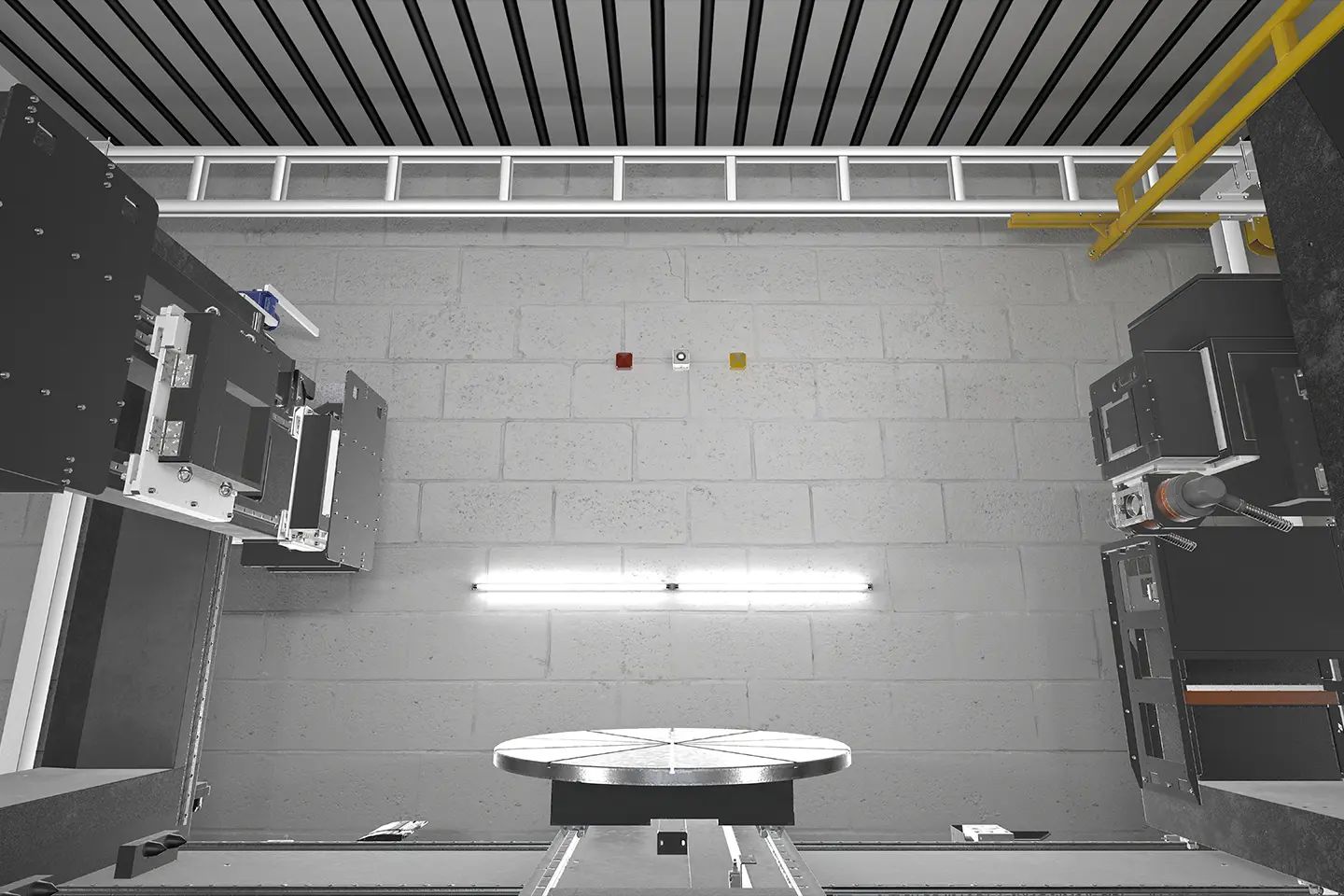 Top-down view into the interior of a large X-ray inspection system with a turntable and inspection equipment on both sides